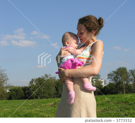 mother sitting with baby on meadow. mother sitting with baby on meadow. 3773552