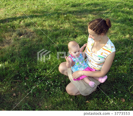 mother sitting with baby on meadow. mother sitting with baby on meadow. 3773553