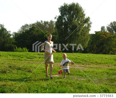 mother with child on meadow 3773563