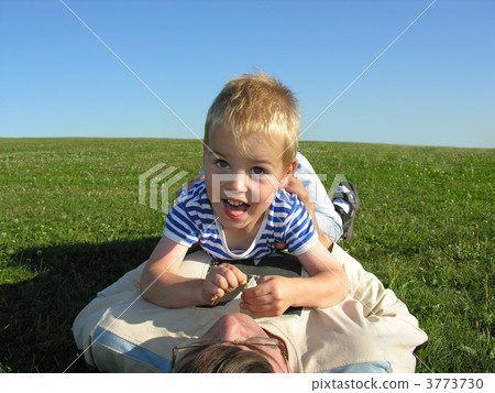 son lie on ather on green grass son lie on ather on green grass 3773730