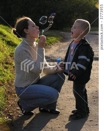 mother with son on sundown with soapy bubble mother with son on sundown with soapy bubble 3773955