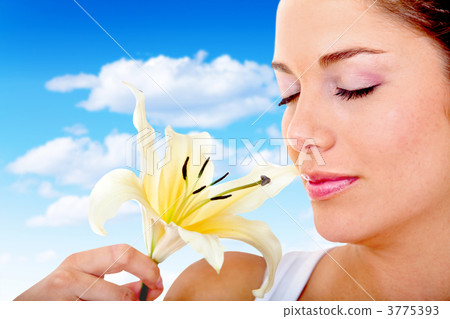 Woman smelling a flower Woman smelling a flower 3775393
