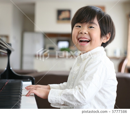 A boy playing the piano A boy playing the piano 3777386