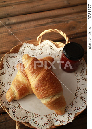 Croissants and strawberry jam on a basket tray 3781177