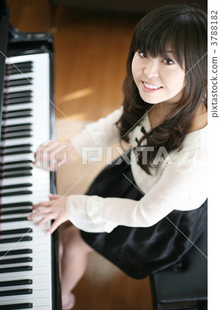 A woman playing the piano with a smile A woman playing the piano with a smile 3788182