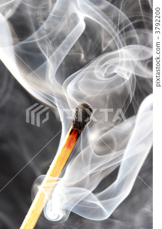 Photo of a burning match in a smoke on a black background Photo of a burning match in a smoke on a black background 3792200