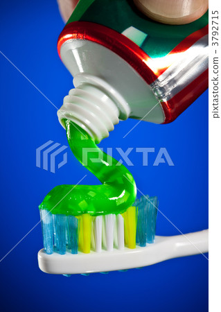 toothpaste being squeezed onto a toothbrush 3792715