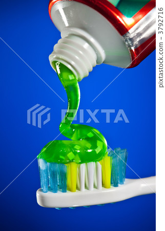 toothpaste being squeezed onto a toothbrush 3792716