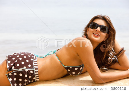 Woman lying at the beach 3800118