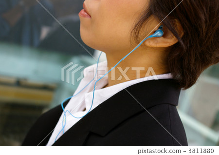 A woman with an earphone 3811880