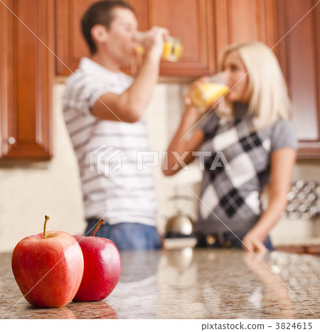Young Couple Drinking Glass of Orange Juice 3824615