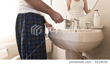 Man Holding Razor in Sink with Water Running 3824636