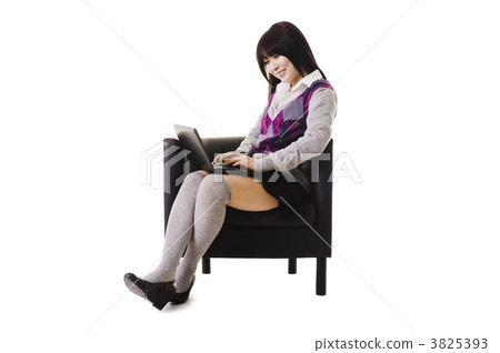 Chinese student working on a laptop and sitting in a chair. 3825393