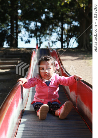 Three year old girls sliding on the slide 3839260