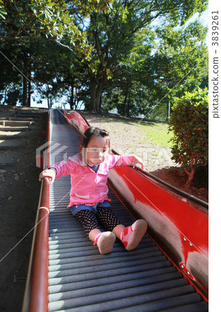 Three year old girls sliding on the slide 3839261