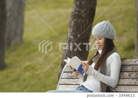 A woman reading in the park A woman reading in the park 3849613