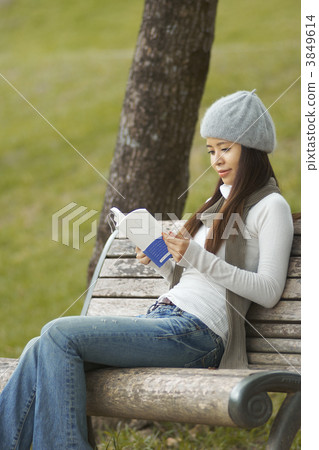 A woman reading in the park A woman reading in the park 3849614