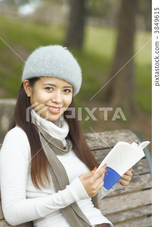 A woman reading in the park A woman reading in the park 3849615