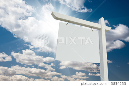 Blank Real Estate Sign over Clouds and Blue Sky Blank Real Estate Sign over Clouds and Blue Sky 3854233