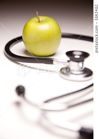 Stethoscope and Green Apple on Gradated Background 3863482