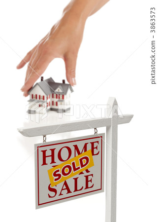 Womans Hand Choosing Home with Sold Real Estate Sign Womans Hand Choosing Home with Sold Real Estate Sign 3863573