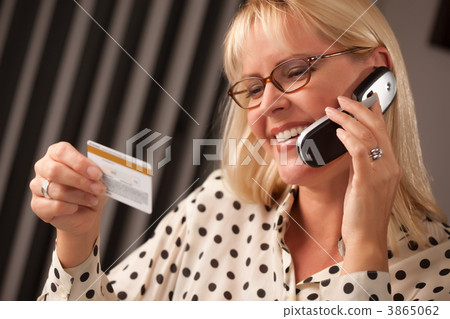 Beautiful Woman on Phone Holding Credit Card 3865062
