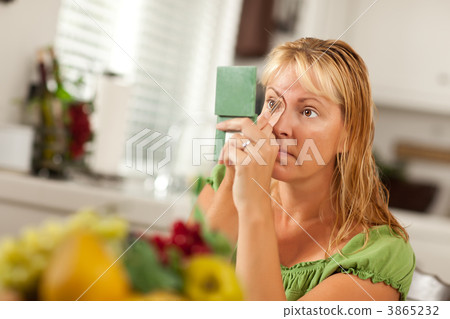 Blonde Woman Applying Her Makeup Blonde Woman Applying Her Makeup 3865232