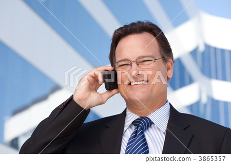 Businessman Smiles as He Talks on His Cell Phone 3865357