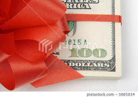 One Hundred Dollar Bills Wrapped in Red Ribbon. 3865834