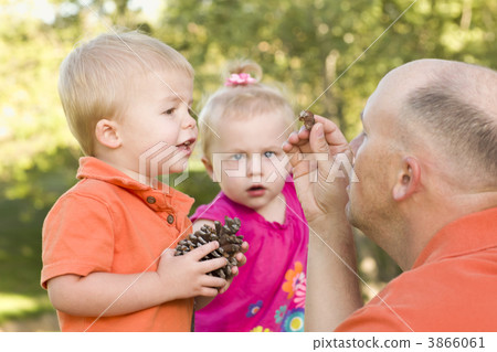 Cute Twin Children Talk with Dad in Park 3866061