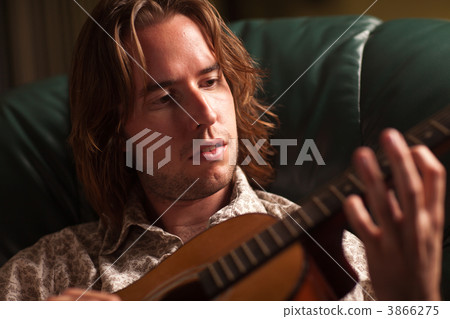 Young Musician Plays His Acoustic Guitar Young Musician Plays His Acoustic Guitar 3866275