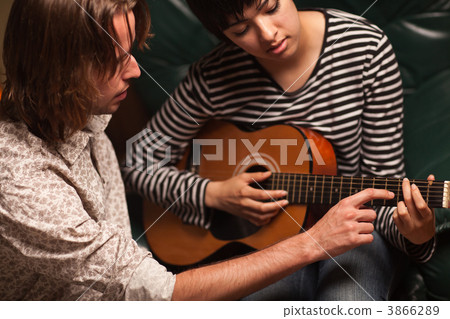Young Musician Teaches Female Student To Play the Guitar Young Musician Teaches Female Student To Play the Guitar 3866289