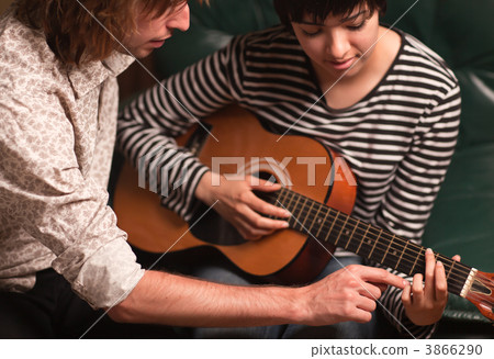 Young Musician Teaches Female Student To Play the Guitar Young Musician Teaches Female Student To Play the Guitar 3866290