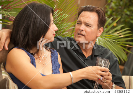 Attractive Hispanic and Caucasian Couple Drinking Wine Attractive Hispanic and Caucasian Couple Drinking Wine 3868112