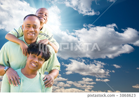 Happy African American Family Over Blue Sky and Clouds Happy African American Family Over Blue Sky and Clouds 3868623