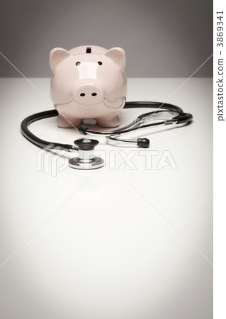 Piggy Bank and Stethoscope with Selective Focus Piggy Bank and Stethoscope with Selective Focus 3869341