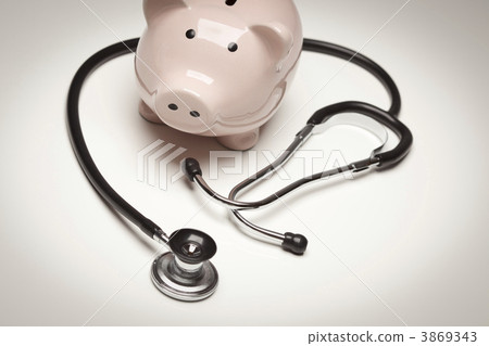 Piggy Bank and Stethoscope with Selective Focus Piggy Bank and Stethoscope with Selective Focus 3869343