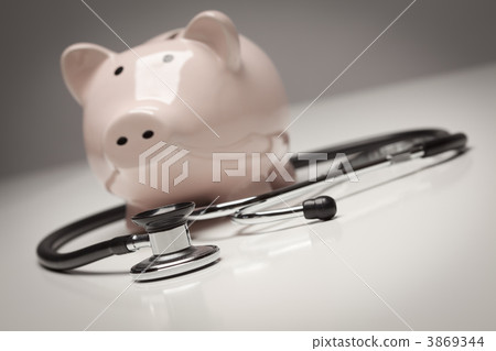Piggy Bank and Stethoscope with Selective Focus 3869344