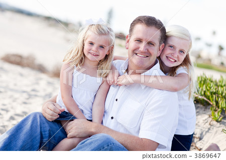 Handsome Dad and His Cute Daughters at The Beach 3869647