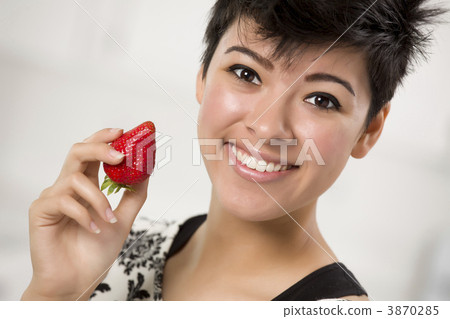 Pretty Hispanic Woman Holding Strawberry 3870285