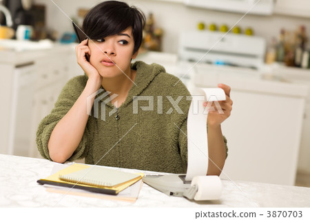 Multi-ethnic Young Woman Agonizing Over Financial Calculations Multi-ethnic Young Woman Agonizing Over Financial Calculations 3870703