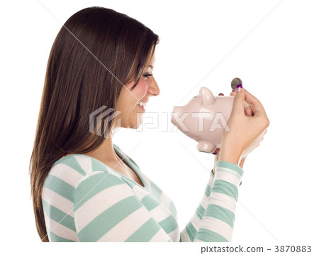 Ethnic Female Putting Coin Into Piggy Bank on White Ethnic Female Putting Coin Into Piggy Bank on White 3870883