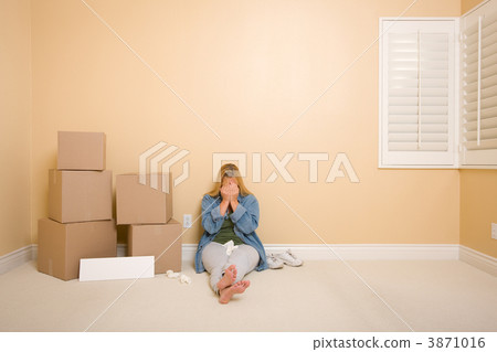 Upset Woman on Floor Next to Boxes and Blank Sign 3871016