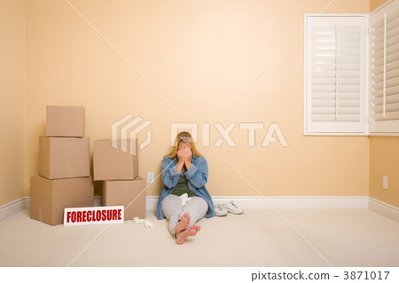 Upset Woman on Floor Next to Boxes and Foreclosure Sign 3871017