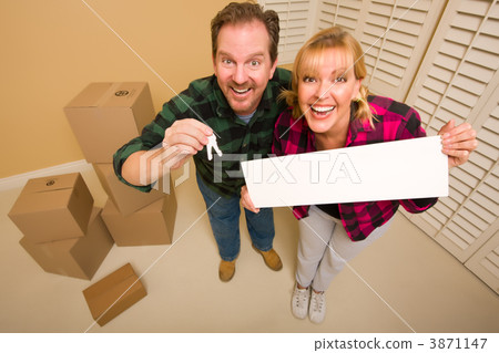 Goofy Couple Holding Keys and Blank Sign Surrounded by Boxes Goofy Couple Holding Keys and Blank Sign Surrounded by Boxes 3871147