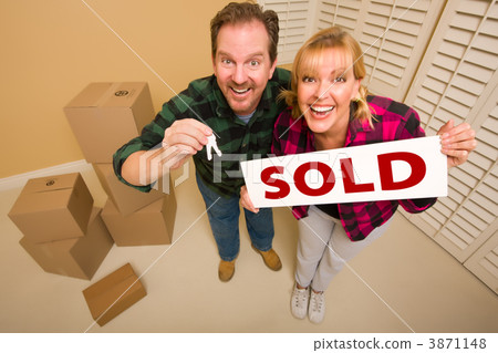 Goofy Couple Holding Key and Sold Sign Surrounded by Boxes Goofy Couple Holding Key and Sold Sign Surrounded by Boxes 3871148