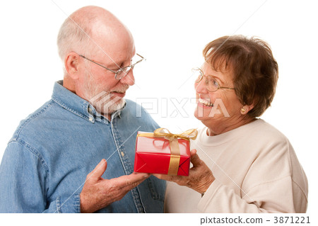 Happy Senior Couple with Gift Happy Senior Couple with Gift 3871221