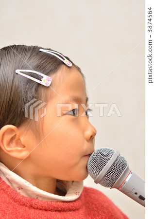 A girl singing with a microphone A girl singing with a microphone 3874564