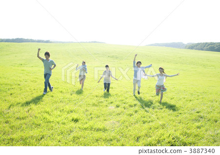 Young people running in the meadow Young people running in the meadow 3887340