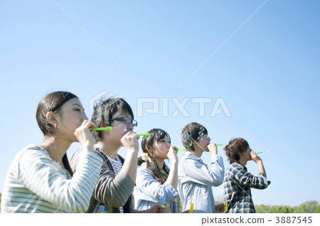Young people playing bubbles Young people playing bubbles 3887545